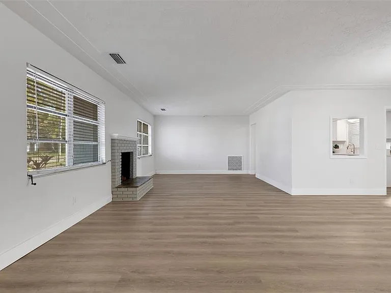 Luxury vinyl plank (LVP) flooring in a living room with fireplace in St. Pete Beach, FL